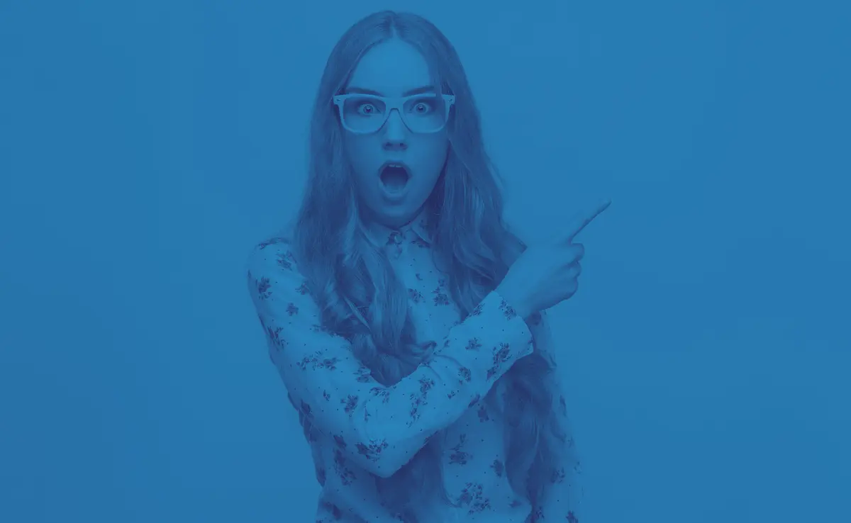 a photo of a surprised woman pointing to her right.