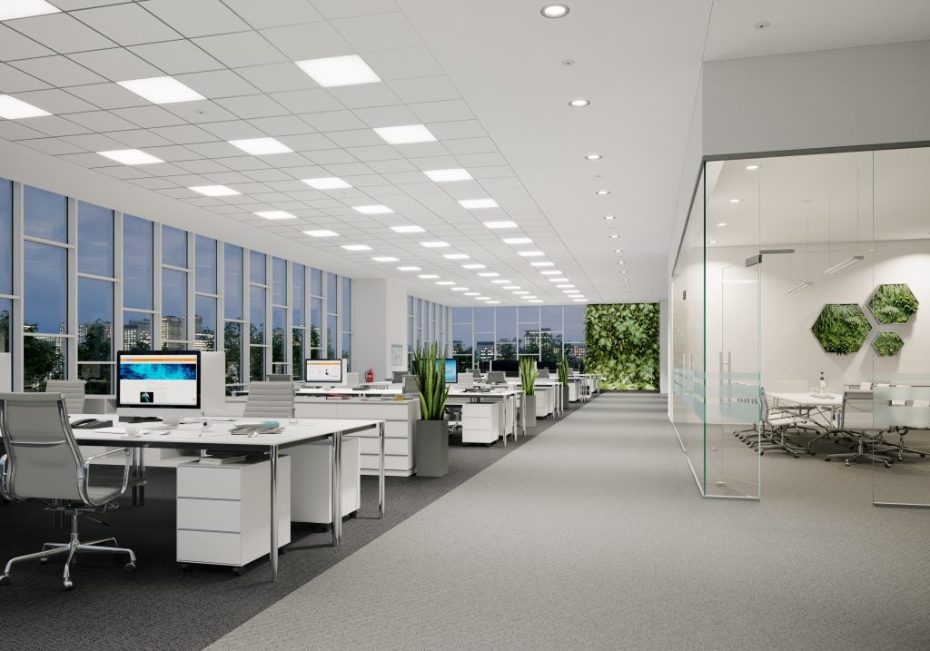 A rendering of a modern, open style office, with desks against the windows on the left side, offices with glass walls on the right. A bank of three rows of lights across the ceiling. 