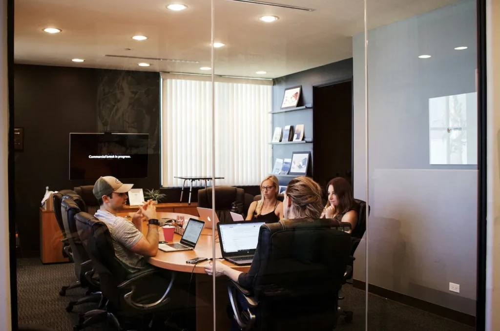 Team meeting in modern glass-walled conference room