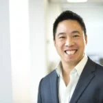 Smiling businessman in a navy suit in an office