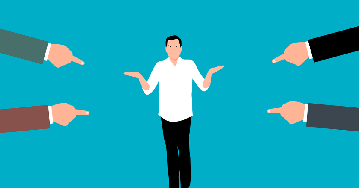 An illustration of hands pointing at a man like they are accusing him of being at fault. The man holds his hands up in a "i don't know" motion.