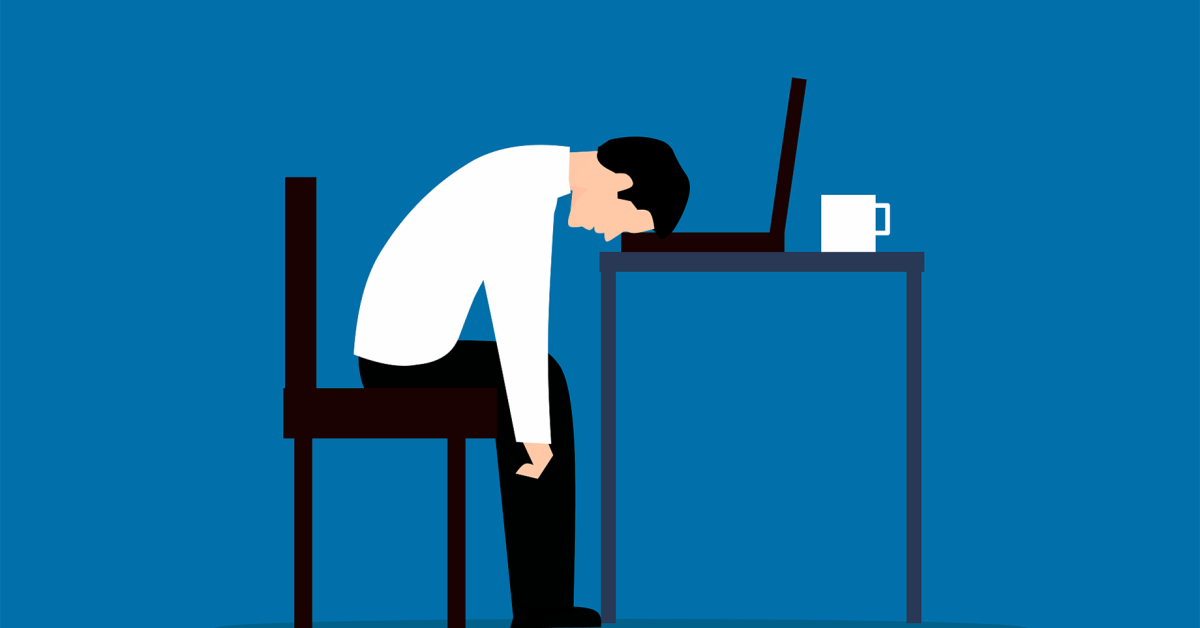 A vector illustration of a frustrated office worker at a desk with his head down on his laptop.computer