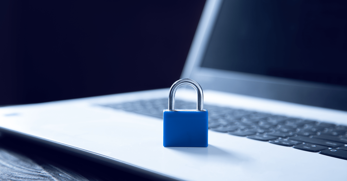A photograph of a blue pad lock on top of an open laptop